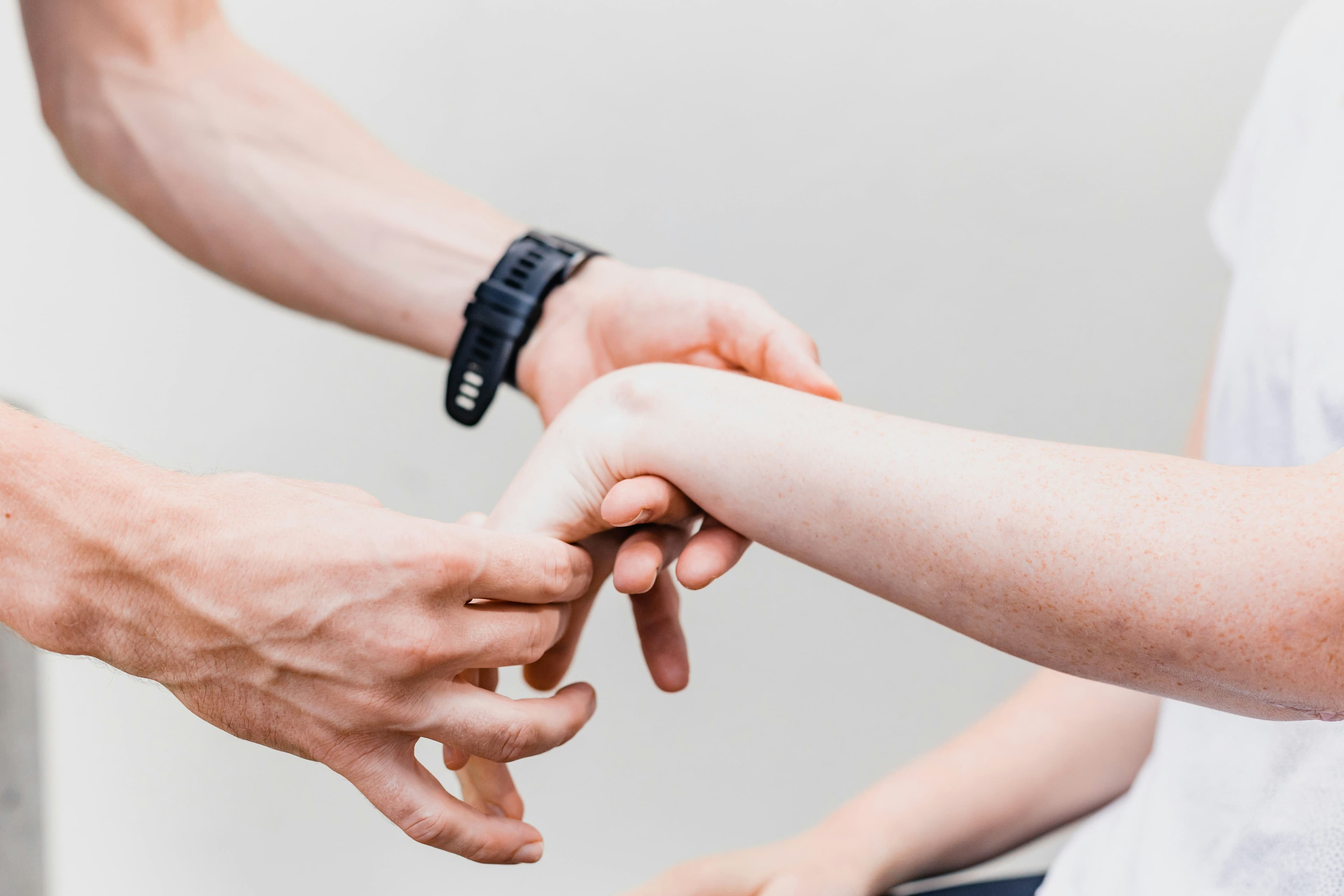 Physiotherapist helping patient with hand exercises